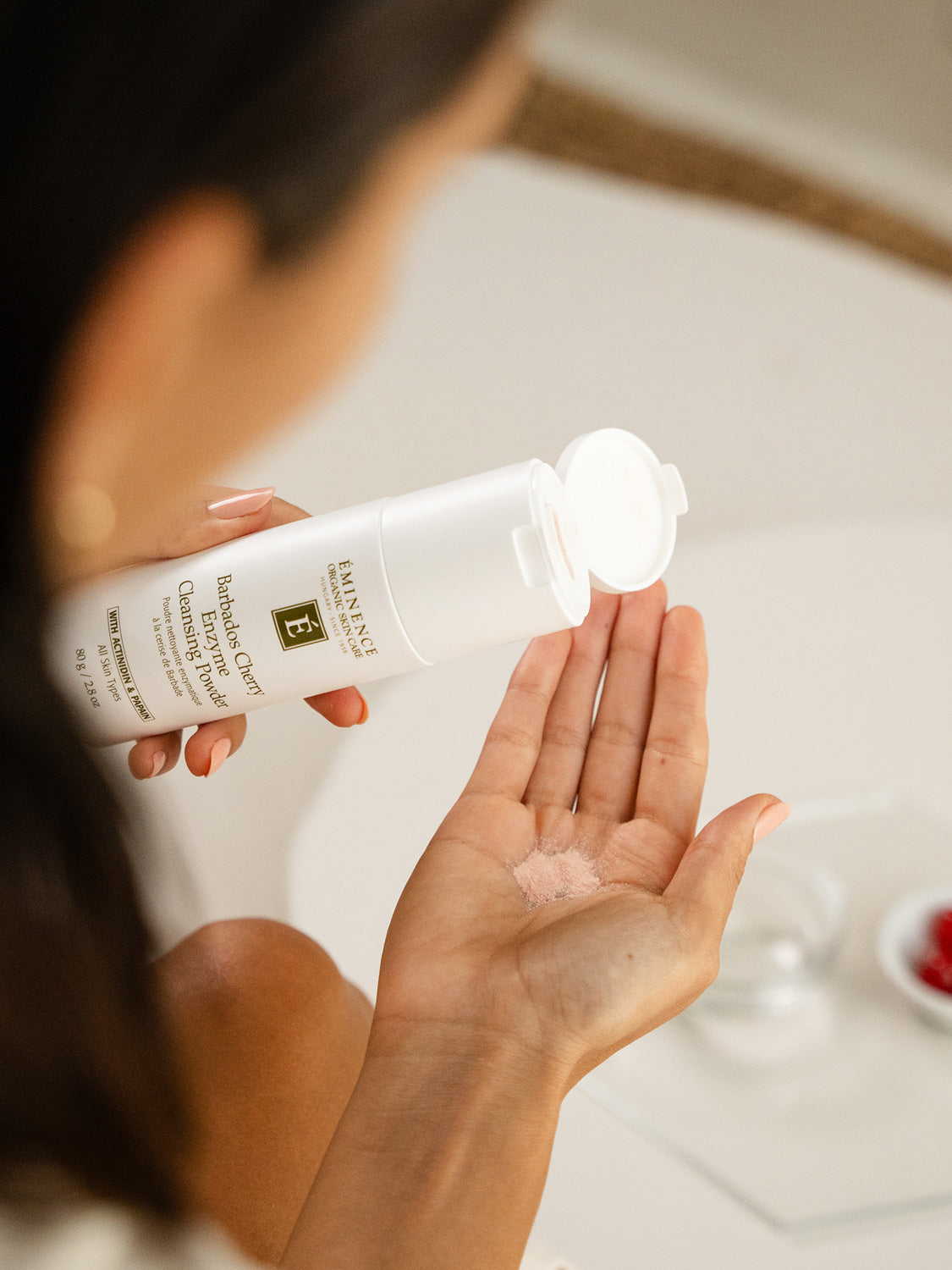 Person holding a bottle of Eucerin baby lotion with a blurred background