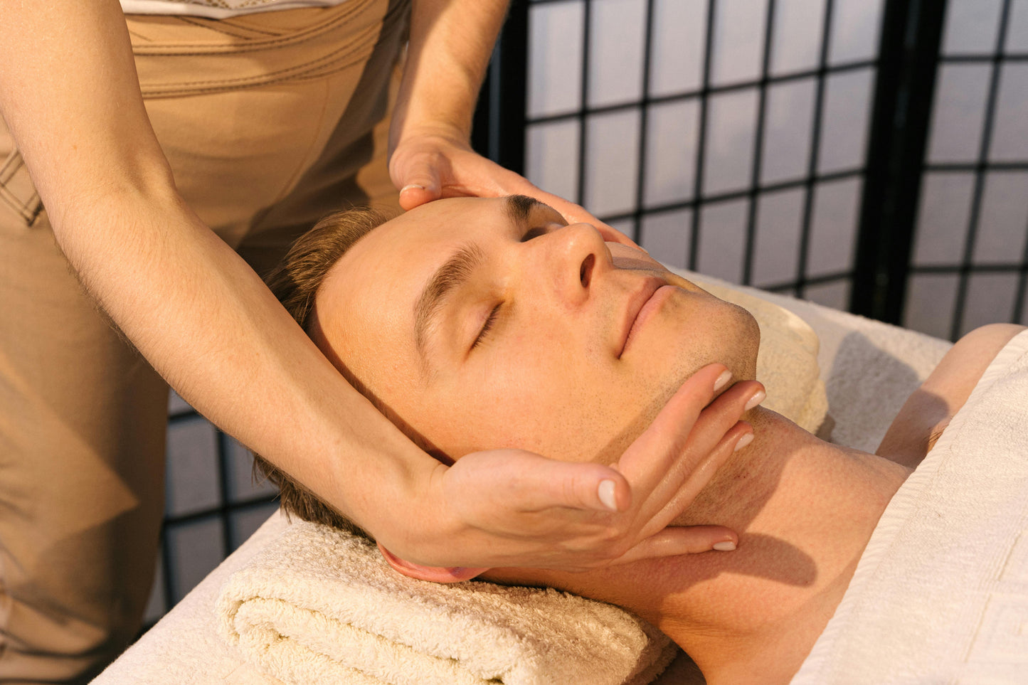 Person receiving a facial massage in a spa setting