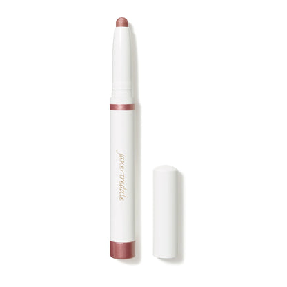 A cream-to-powder eye shadow stick in a matte pink shade, with a built-in sharpener, displayed next to its cap.
