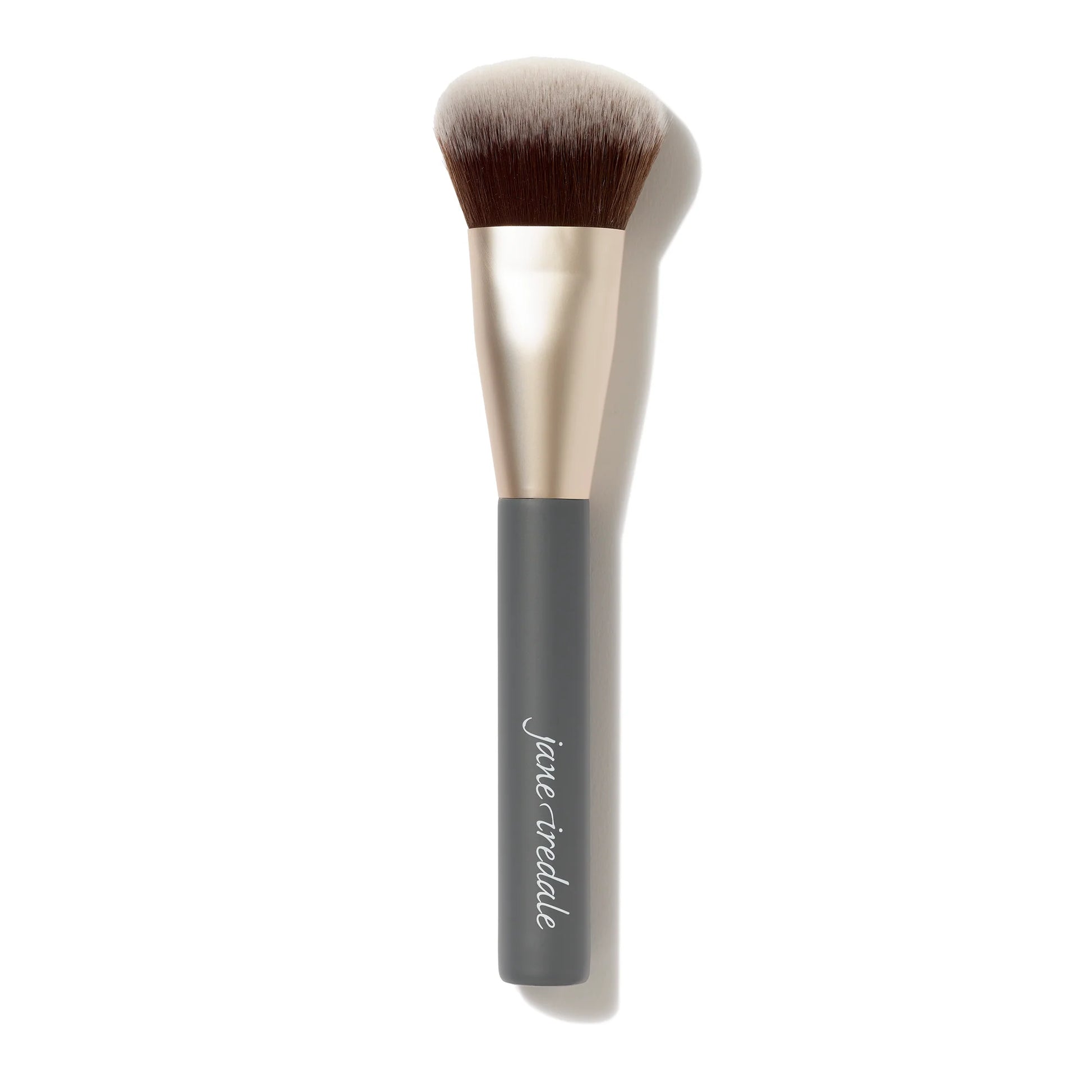 Makeup brush with black handle and beige bristles on a white background