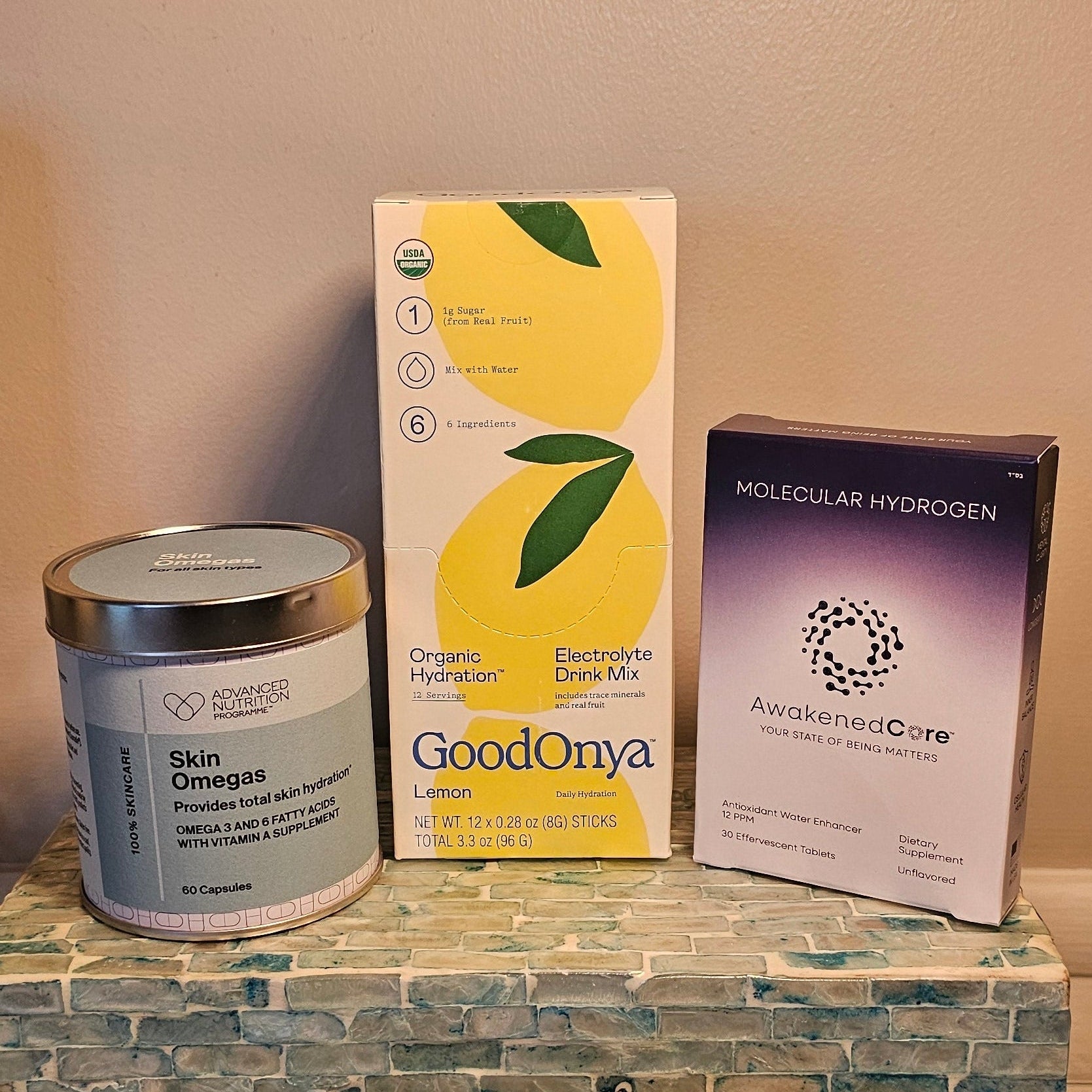 Decorative items on a shelf including candles, a box, and a can.