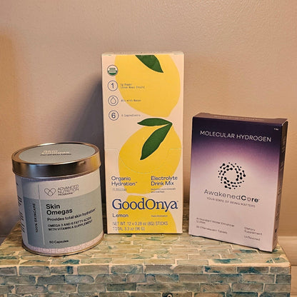 Decorative items on a shelf including candles, a box, and a can.