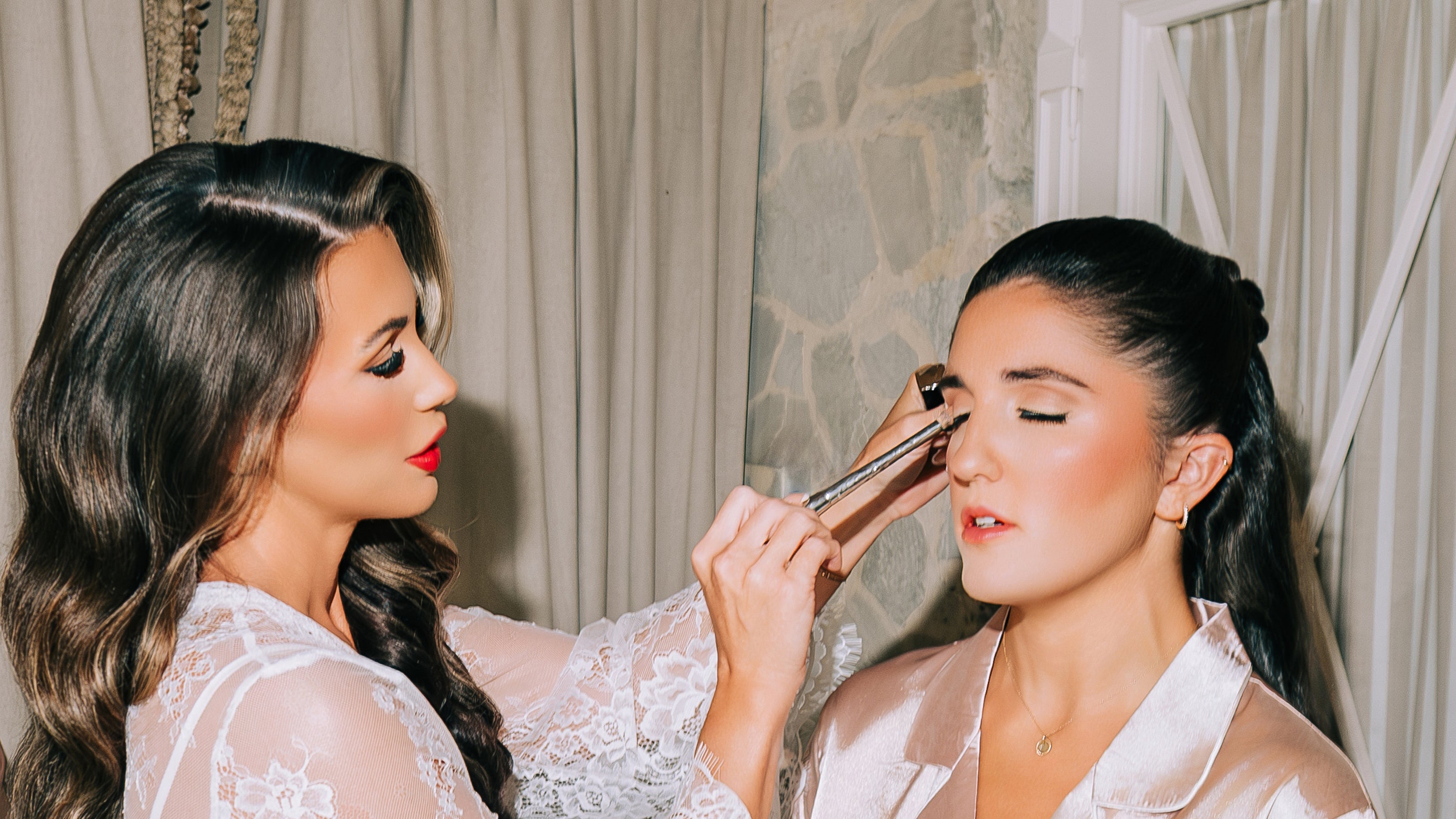 Professional makeup artist applying makeup during a glam beauty appointment