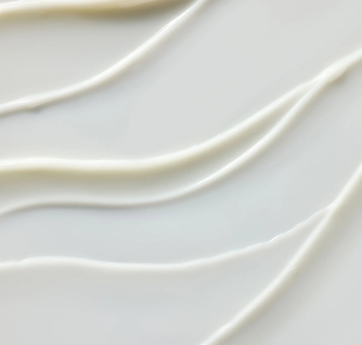 Close-up of smooth, white ceramic tiles with wavy patterns