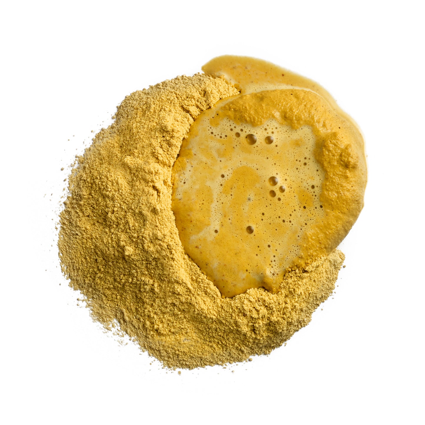 Yellow bath bomb with powder around it on a white background