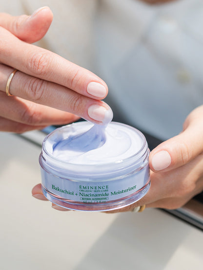 Person holding a jar of Eminence Balchuchid + Niacinamide Moisturizer with a close-up of the cream.