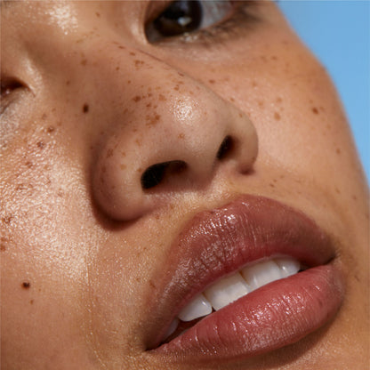 Close-up of lips against a clear blue sky, from Irene Forte's Bio-Peptide Lip Treatment imagery