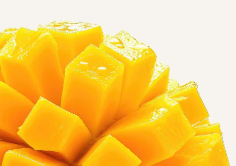Cubed mango pieces on a white background