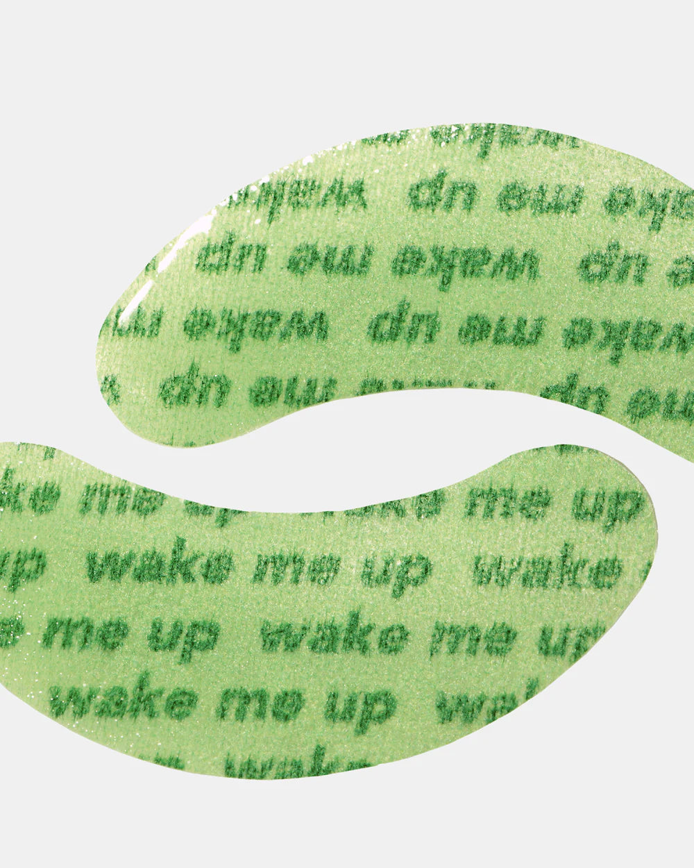Green eye mask with text 'wake me up' on a white background