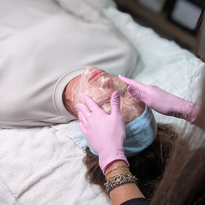Close-up of a relaxing facial treatment with cleansing product application at Refined with Caroline