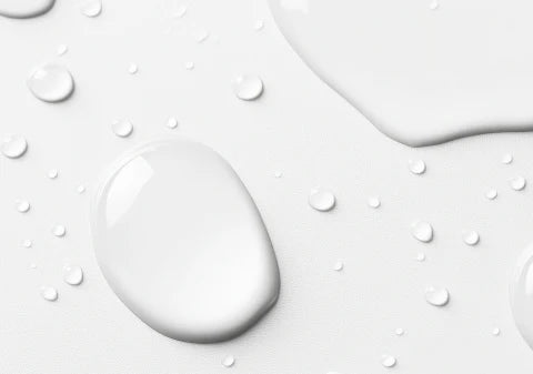 Close-up of water droplets on a light gray surface