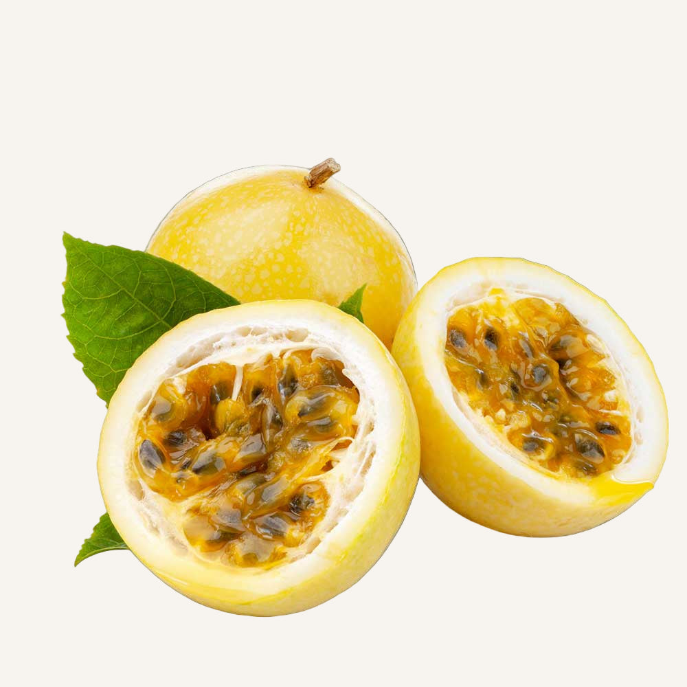 Passion fruit cut in half with a whole fruit on a white background