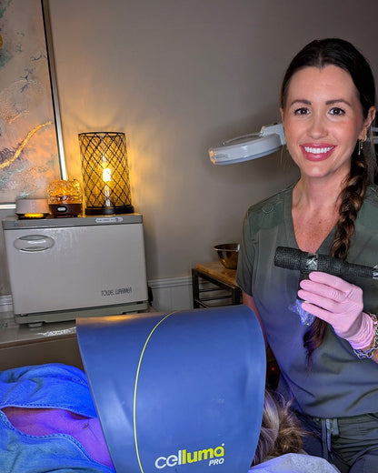 Caroline holding the ProCell microchanneling device beside a client under the Celluma LED light at Skin By Caroline in Rock Hill, SC