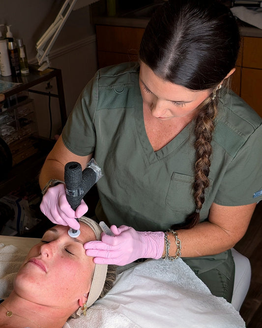 Caroline working the ProCell microchanneling device across a client's forehead, seen from above