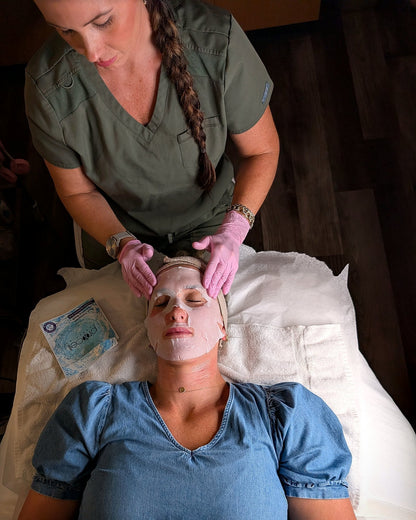 Client wearing the post-treatment mask after microchanneling, with the ProCell recovery kit beside her